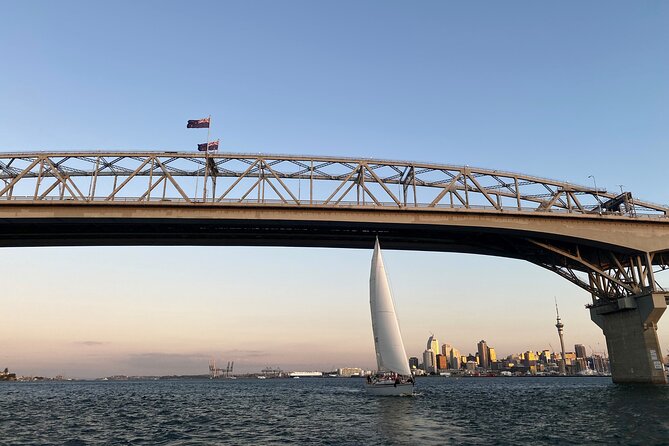 Auckland Harbour Sailboat Cruise Including Three Course Dinner - Auckland Harbour Bridge and the Sky Tower at dusk