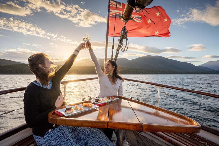 Evening Champagne Cruise on Historic 1935 Motor Yacht. - Hands-on sailing: steering Faith, hoisting sails, and deckhand fun