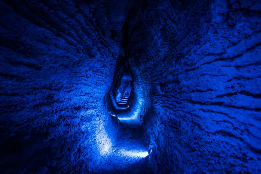 From Auckland: Waitomo Glowworm and Ruakuri Caves Day Tour - Ruakuri Cave walk: spiral entry, shawl-like limestone, and waterfall thunder
