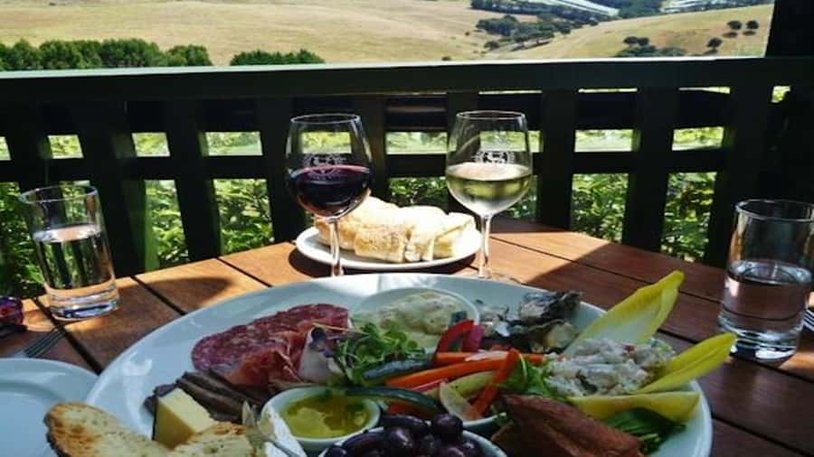 Waiheke: Scenic Taste and Graze Tour with Wine, Whisky, Beer - Driving through Waiheke villages, where the island story feels personal